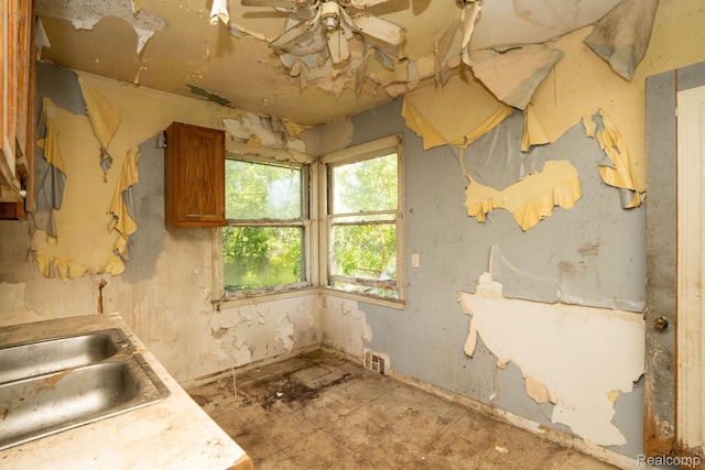 15693 Liberal St, Detroit, MI 48205 - kitchen with a sink, brown cabinetry, and a ceiling fan