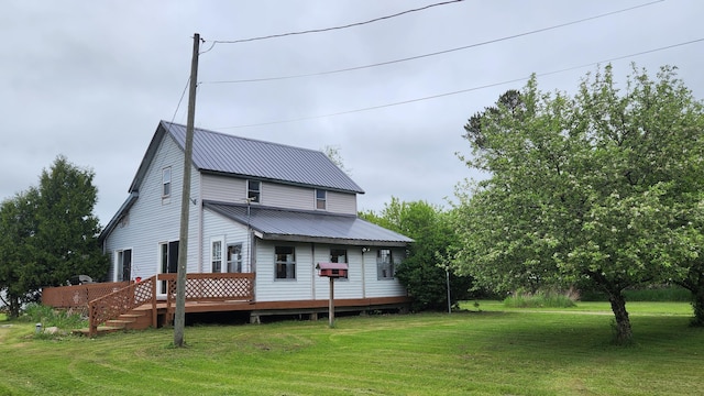 3483 80th Ave, Lakeview, MI 48850 - rear view of house featuring a lawn, a wooden deck, and metal roof