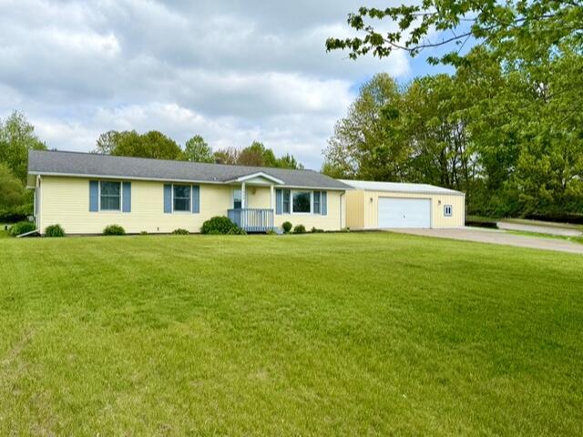 ranch-style home with driveway, a front lawn, and a garage