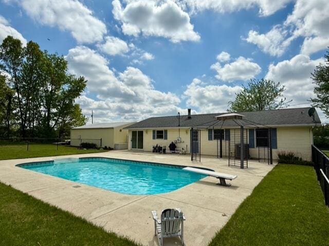 view of pool featuring a patio, a diving board, and cooling unit