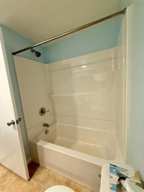 full bathroom with tile patterned flooring, bathtub / shower combination, and toilet