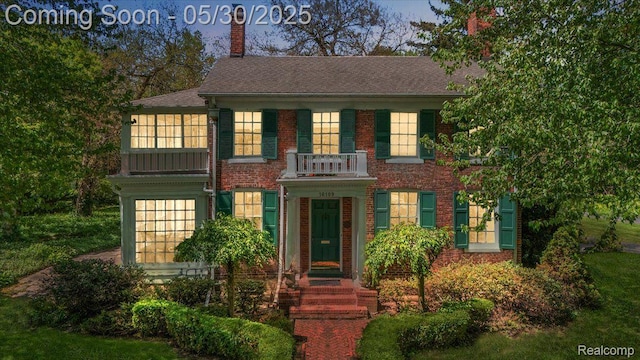 16109 E Jefferson Ave, Grosse Pointe Park, MI 48230 - colonial house featuring a balcony, a chimney, brick siding, and roof with shingles