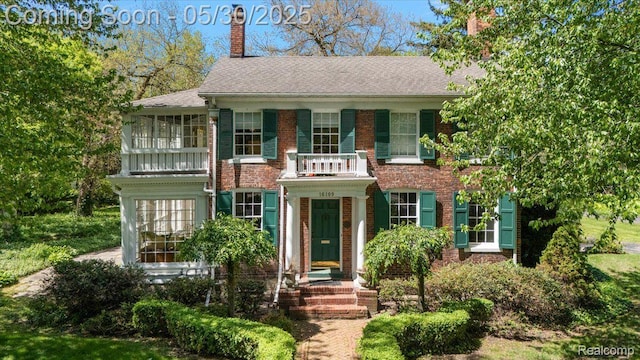 16109 E Jefferson Ave, Grosse Pointe Park, MI 48230 - colonial house with a balcony, a chimney, brick siding, and a shingled roof
