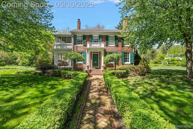 16109 E Jefferson Ave, Grosse Pointe Park, MI 48230 - colonial-style house featuring a front lawn, a chimney, and brick siding
