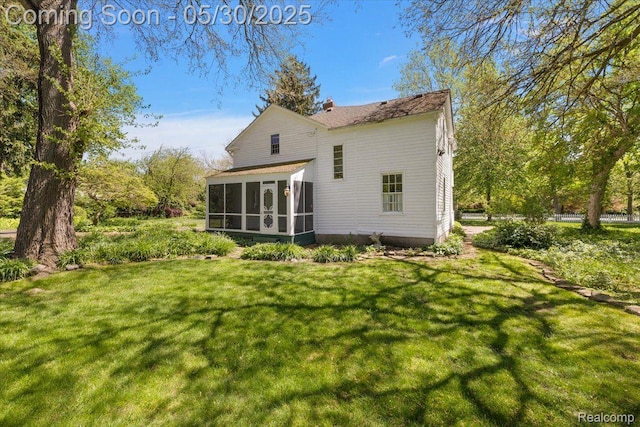 16109 E Jefferson Ave, Grosse Pointe Park, MI 48230 - back of house with a sunroom and a lawn