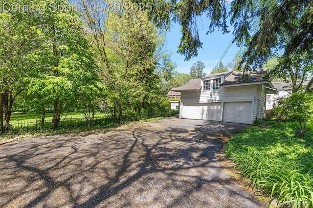 16109 E Jefferson Ave, Grosse Pointe Park, MI 48230 - view of front of house featuring driveway and an attached garage