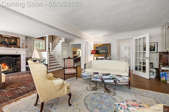 16109 E Jefferson Ave, Grosse Pointe Park, MI 48230 - living area featuring crown molding, a warm lit fireplace, stairway, wood finished floors, and french doors