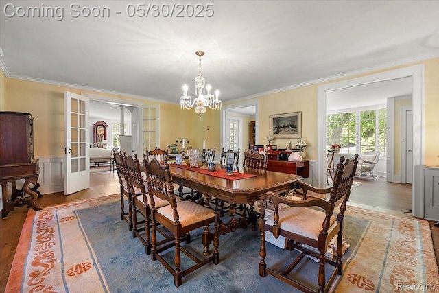 16109 E Jefferson Ave, Grosse Pointe Park, MI 48230 - dining room with a chandelier, ornamental molding, wood finished floors, french doors, and a wainscoted wall