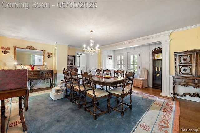 16109 E Jefferson Ave, Grosse Pointe Park, MI 48230 - dining space featuring crown molding, a chandelier, a decorative wall, and wood finished floors