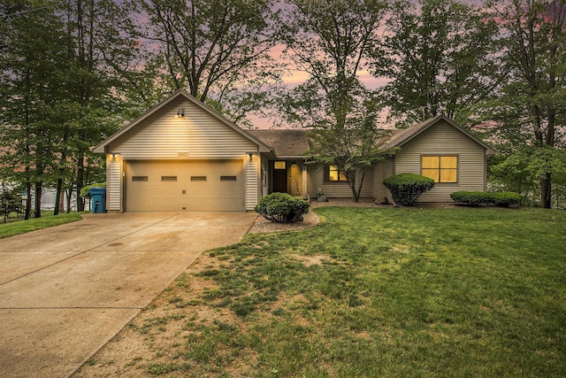 ranch-style home with concrete driveway, an attached garage, and a front lawn