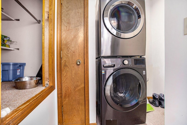 laundry room with stacked washer / dryer