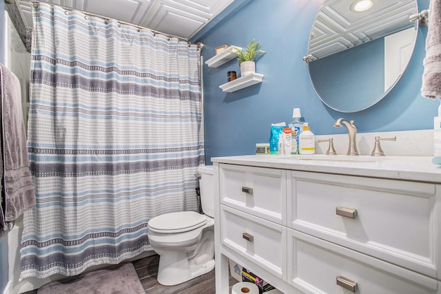 full bathroom featuring toilet, an ornate ceiling, vanity, wood finished floors, and a shower with shower curtain