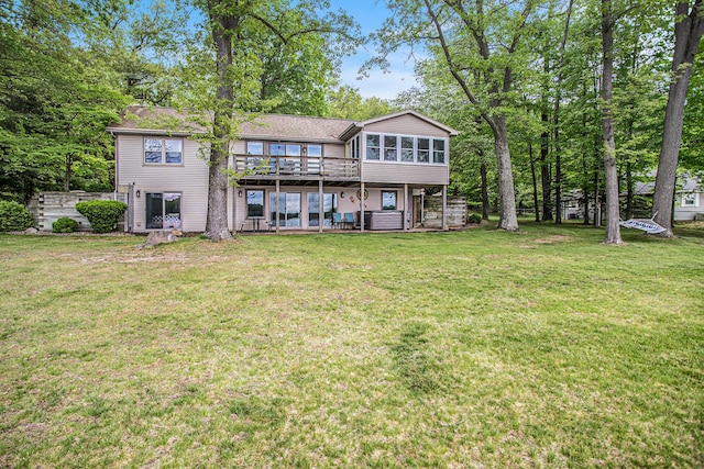 rear view of house with a yard and a deck