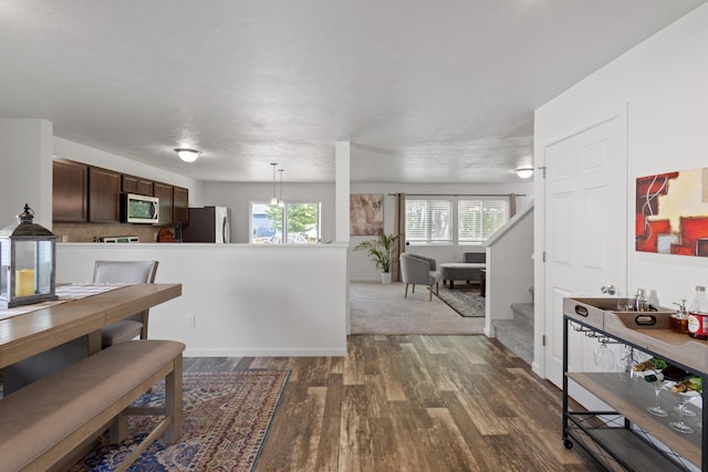 25596 Forest Dr, Mattawan, MI 49071 - dining room featuring dark wood finished floors and stairway