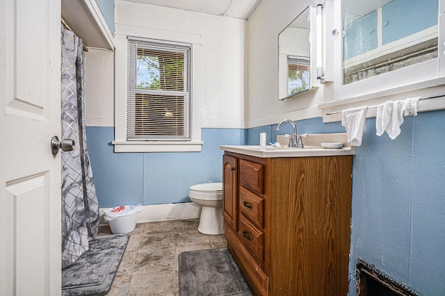 791 La Salle St, Benton Harbor, MI 49022 - bathroom featuring toilet, vanity, stone finish floors, and a shower with shower curtain