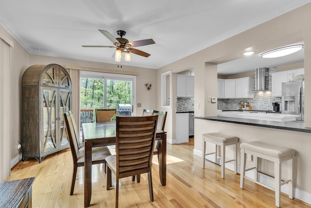 6550 Avon Dr, Brighton, MI 48116 - dining space featuring ceiling fan, crown molding, light wood-style flooring, and baseboards