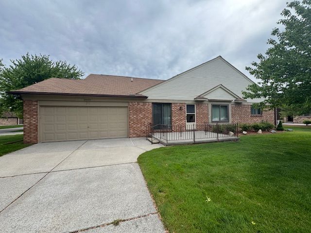 20433 Birch Meadow Dr, Clinton Township, MI 48036 - ranch-style house featuring a garage, concrete driveway, brick siding, and a front yard