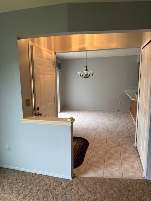 20433 Birch Meadow Dr, Clinton Township, MI 48036 - kitchen with a chandelier, tile patterned floors, and carpet