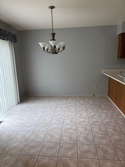20433 Birch Meadow Dr, Clinton Township, MI 48036 - unfurnished dining area with a chandelier and light tile patterned floors