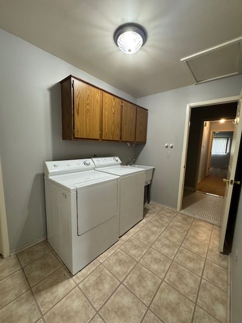 20433 Birch Meadow Dr, Clinton Township, MI 48036 - laundry area with cabinet space, attic access, separate washer and dryer, and light tile patterned floors