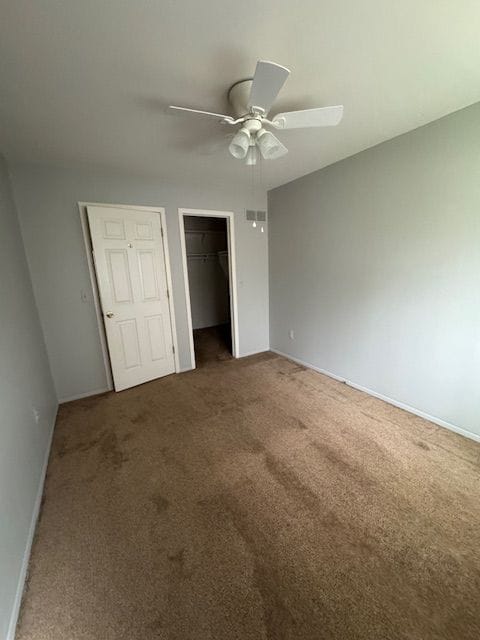 20433 Birch Meadow Dr, Clinton Township, MI 48036 - unfurnished bedroom with carpet floors, baseboards, a ceiling fan, and a closet