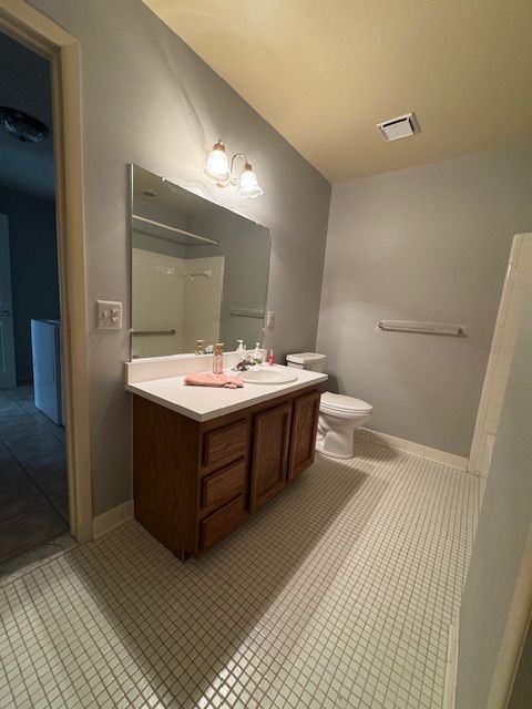 20433 Birch Meadow Dr, Clinton Township, MI 48036 - bathroom with toilet, double vanity, tile patterned floors, and baseboards
