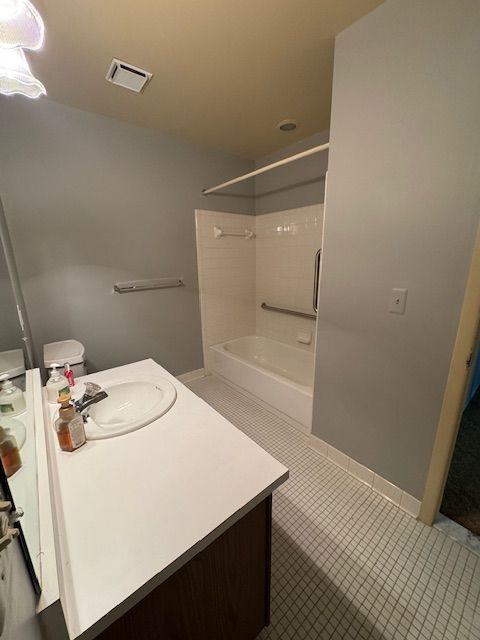 20433 Birch Meadow Dr, Clinton Township, MI 48036 - full bath with tile patterned floors, bathing tub / shower combination, vanity, and baseboards