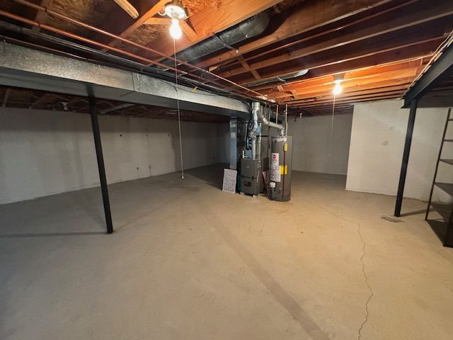 20433 Birch Meadow Dr, Clinton Township, MI 48036 - unfinished below grade area with water heater and heating unit