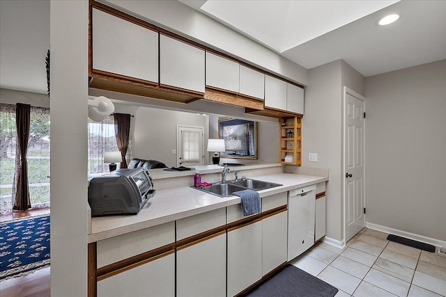 14829 Mayview, Shelby Twp, MI 48315 - kitchen featuring white dishwasher, a sink, light countertops, white cabinetry, and baseboards