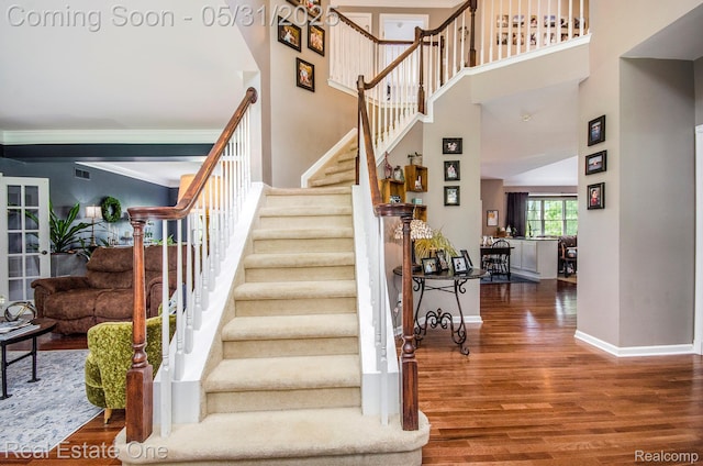 3088 Exeter Dr, Milford, MI 48380 - stairs featuring wood finished floors, a high ceiling, and baseboards