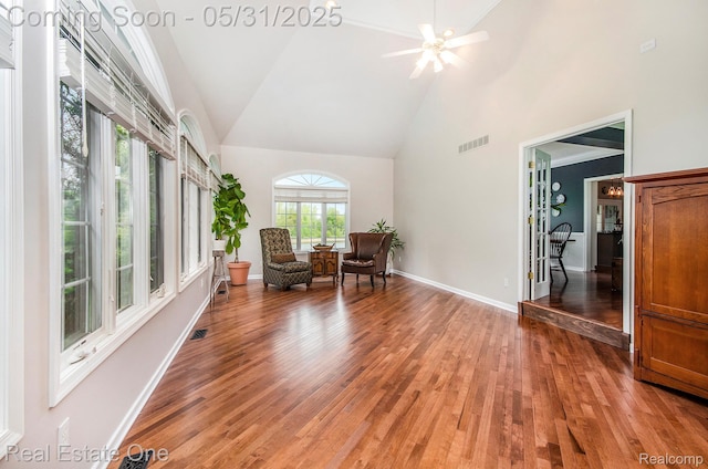 3088 Exeter Dr, Milford, MI 48380 - living area featuring high vaulted ceiling, light wood-type flooring, a ceiling fan, and baseboards