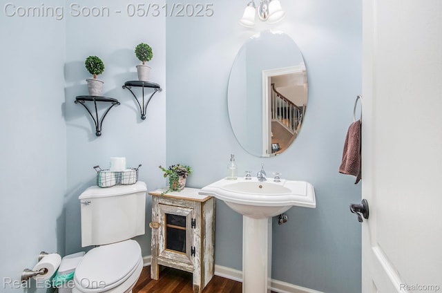 3088 Exeter Dr, Milford, MI 48380 - half bath with toilet, wood finished floors, and baseboards
