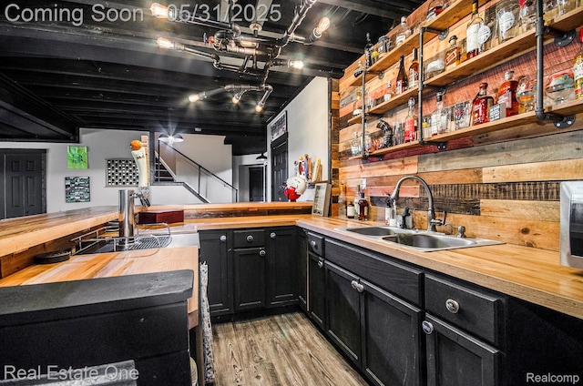 3088 Exeter Dr, Milford, MI 48380 - indoor bar with light wood-style floors and stairway