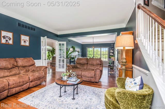 3088 Exeter Dr, Milford, MI 48380 - living room featuring crown molding, wood finished floors, french doors, and stairway