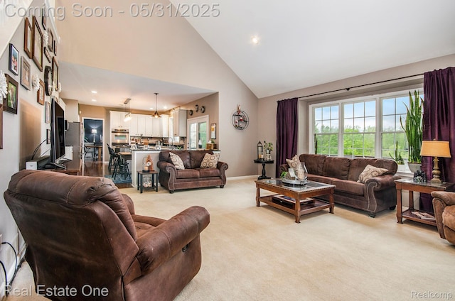 3088 Exeter Dr, Milford, MI 48380 - living room with high vaulted ceiling, light colored carpet, recessed lighting, and baseboards