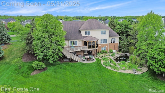 3088 Exeter Dr, Milford, MI 48380 - rear view of house featuring stairway, a deck, a lawn, a patio area, and brick siding