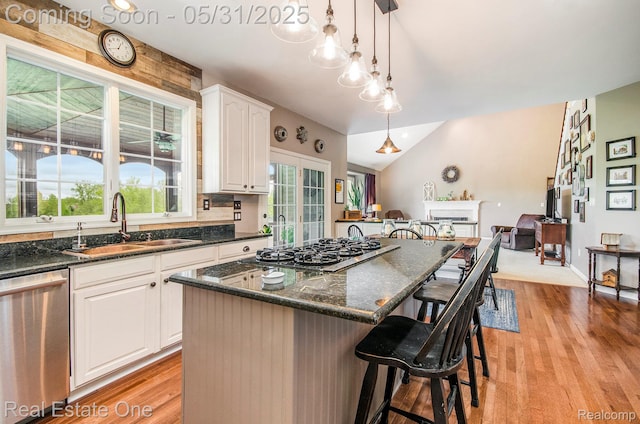 3088 Exeter Dr, Milford, MI 48380 - kitchen with appliances with stainless steel finishes, a sink, a kitchen bar, light wood-style flooring, and white cabinets