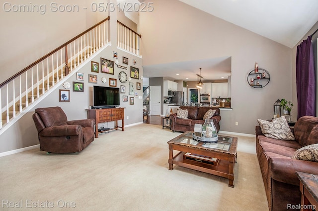 3088 Exeter Dr, Milford, MI 48380 - living room with light colored carpet, stairway, baseboards, and high vaulted ceiling