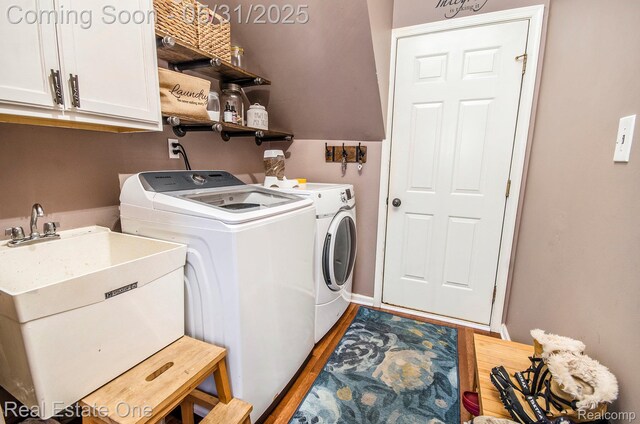 3088 Exeter Dr, Milford, MI 48380 - laundry room with independent washer and dryer, cabinet space, light wood finished floors, and baseboards
