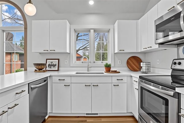 37695 Burton Dr, Farmington Hills, MI 48331 - kitchen featuring appliances with stainless steel finishes, a sink, recessed lighting, light countertops, and white cabinets