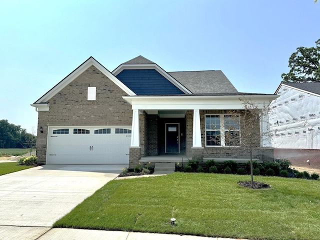 50005 Bluebell St, Canton, MI 48188 - view of front of property featuring a front yard, concrete driveway, brick siding, and covered porch
