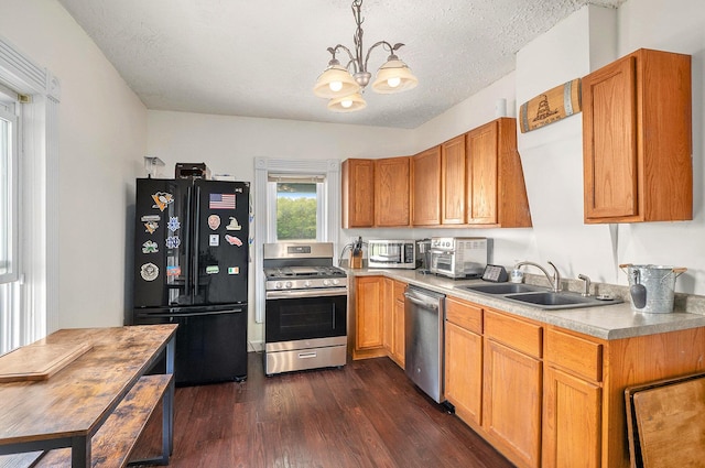 7917 E Harrison Rd, Breckenridge, MI 48615 - kitchen featuring appliances with stainless steel finishes, a sink, dark wood-style floors, a chandelier, and light countertops