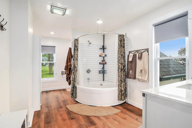 7917 E Harrison Rd, Breckenridge, MI 48615 - bathroom with wood finished floors, shower / tub combo with curtain, recessed lighting, baseboards, and vanity