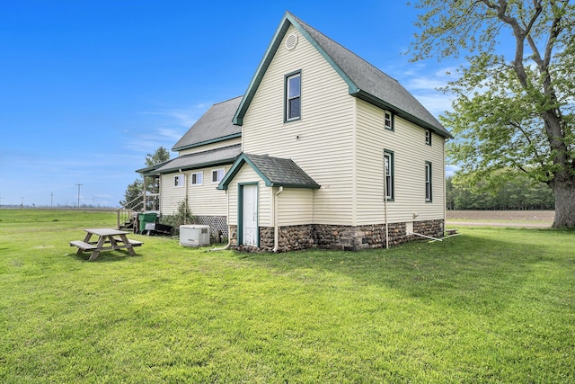 7917 E Harrison Rd, Breckenridge, MI 48615 - rear view of property with a lawn and a shingled roof