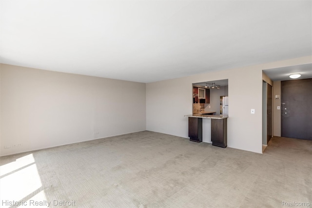 1300 E Lafayette St Unit 2502, Detroit, MI 48207 - unfurnished living room with light colored carpet and a chandelier