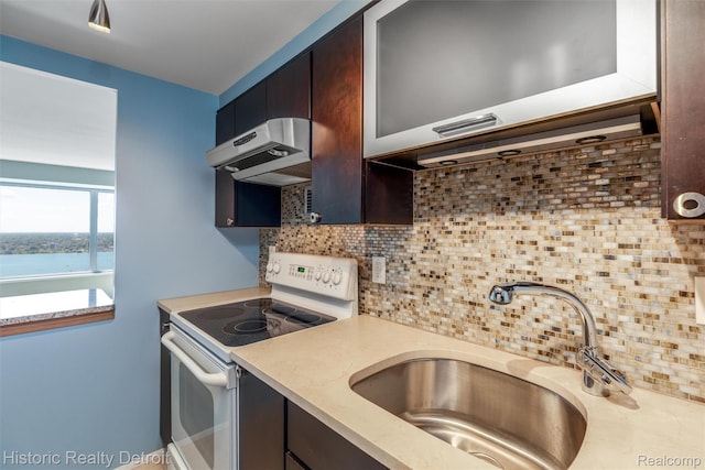 1300 E Lafayette St Unit 2502, Detroit, MI 48207 - kitchen with white range with electric stovetop, a sink, light countertops, and dark brown cabinets