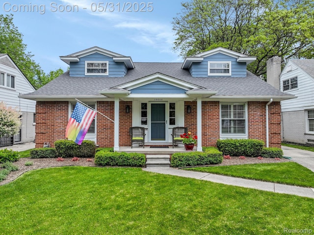 19666 Renfrew Rd, Detroit, MI 48221 - bungalow-style home featuring brick siding, a shingled roof, covered porch, and a front yard