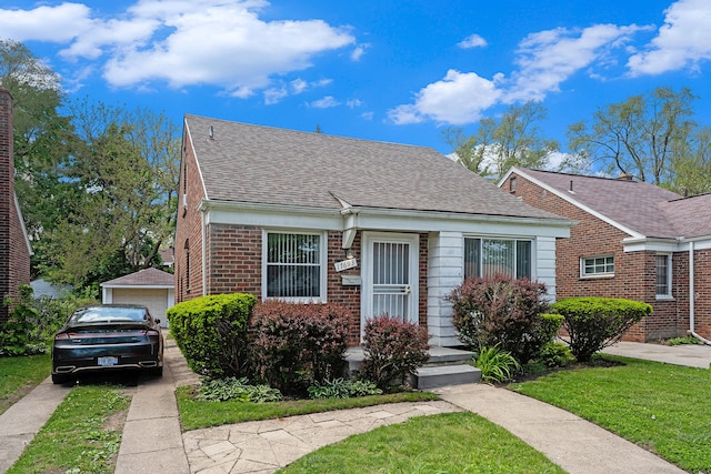 17693 Greenview Ave, Detroit, MI 48219 - bungalow-style house with a front lawn, a shingled roof, a garage, an outbuilding, and brick siding