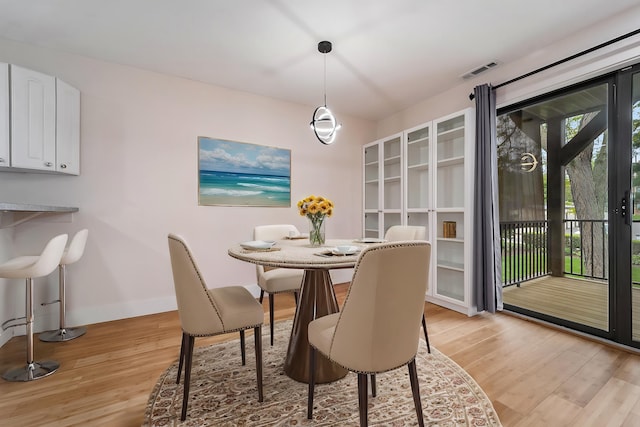 895 S Pontiac Trl Unit C206, Walled Lake, MI 48390 - dining room featuring light wood-type flooring and baseboards