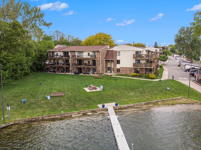 895 S Pontiac Trl Unit C206, Walled Lake, MI 48390 - exterior space featuring a lawn, a water view, and a patio